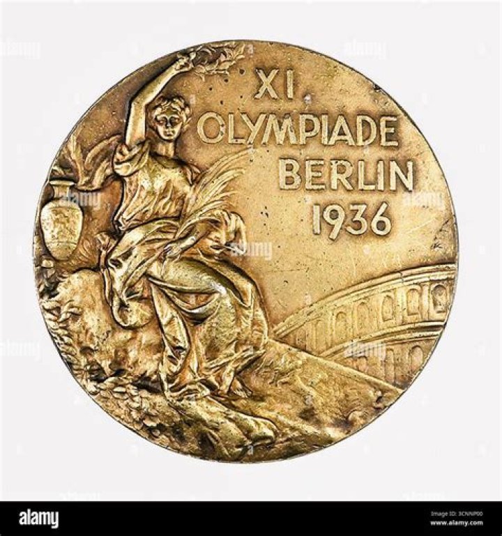 Four-time gold medalist in the 1936 Olympics NYT Crossword Clue